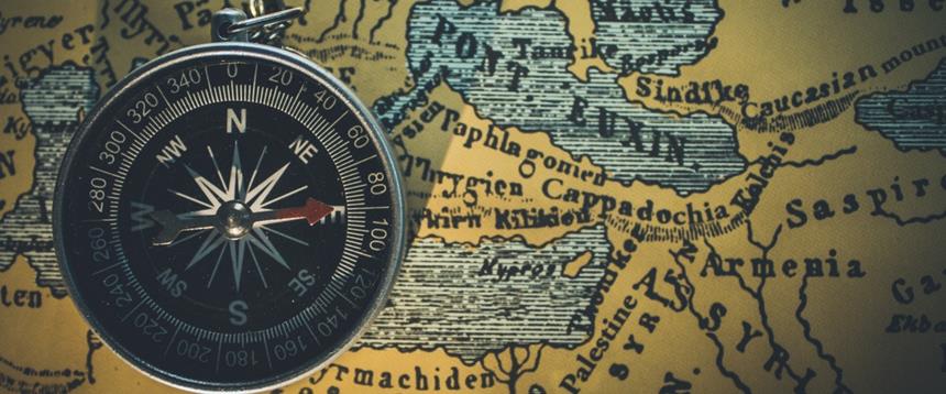 Compass sitting on top of a map