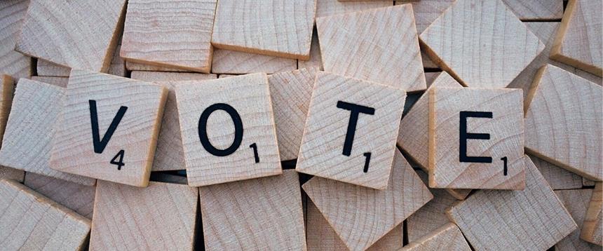 Photo of Scrabble tiles spelling the word VOTE.