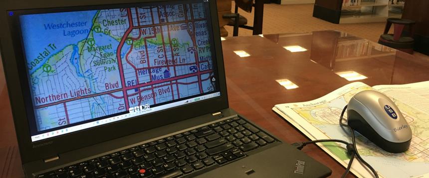 Electronic magnifier showing enlarged map on laptop screen.