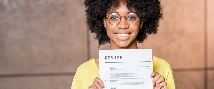 Photo of woman smiling and holding resume
