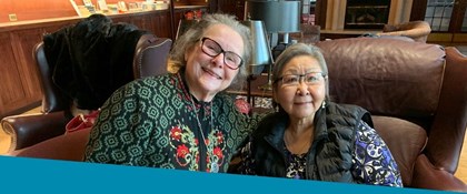 Two senior women sitting together in the Ann Stevens Room at Loussac Library.